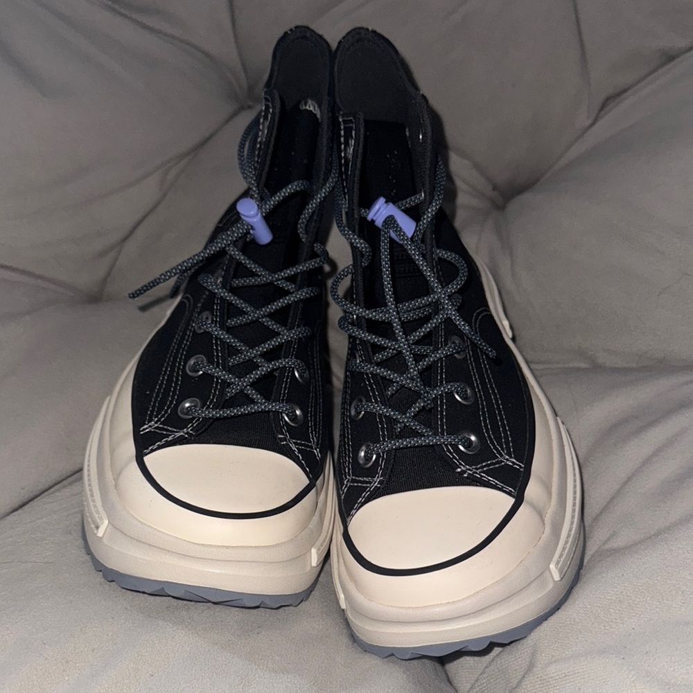 Cream and Black Converse Sneakers with Timeless High-Top Design